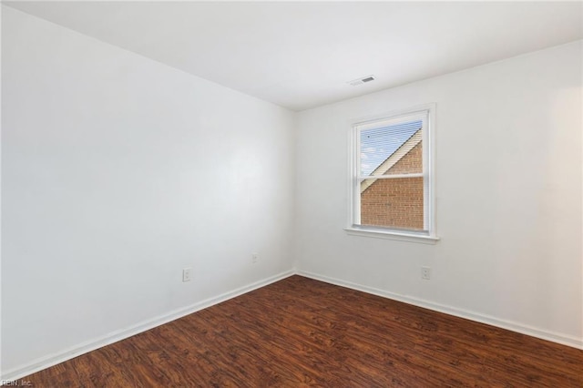 spare room featuring wood-type flooring