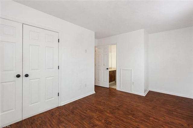 unfurnished bedroom featuring dark hardwood / wood-style flooring and a closet