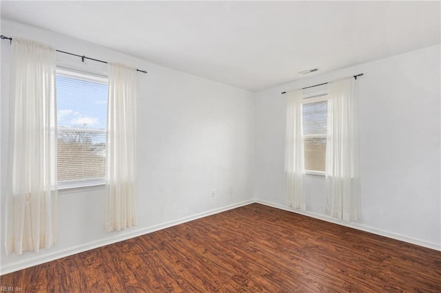 empty room featuring dark wood-type flooring