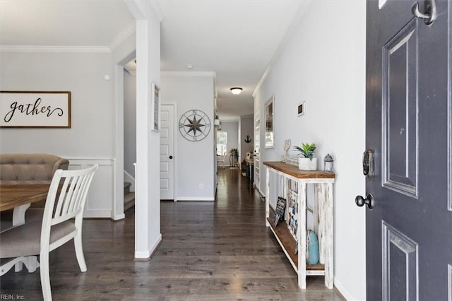 entryway with ornamental molding and dark wood-type flooring