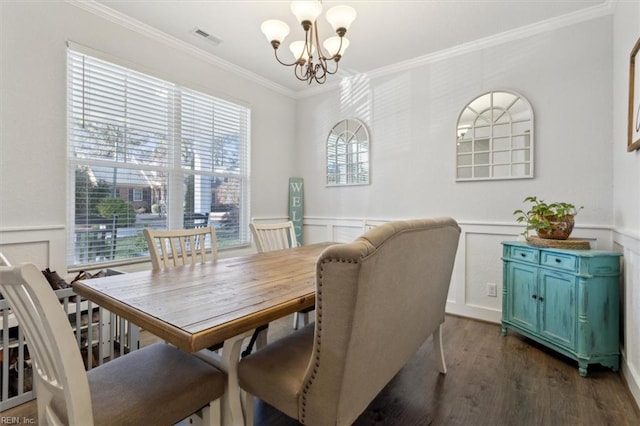 dining room featuring ornamental molding, dark hardwood / wood-style flooring, and a notable chandelier