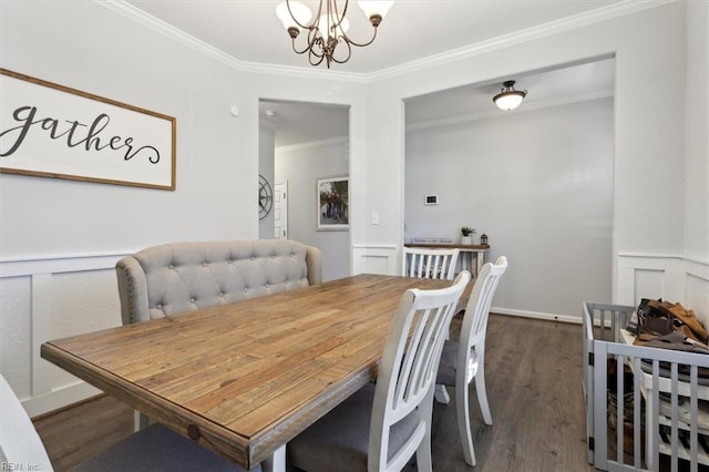 dining space with crown molding, dark hardwood / wood-style flooring, and an inviting chandelier