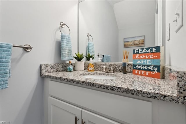 bathroom with vanity and vaulted ceiling