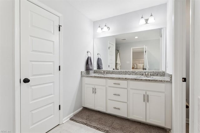 bathroom with tile patterned floors and vanity