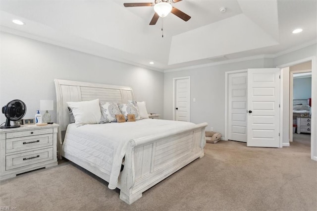 carpeted bedroom featuring ceiling fan, ornamental molding, and a raised ceiling