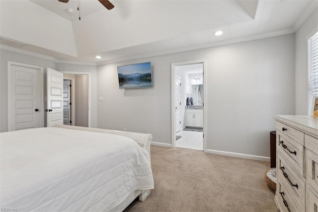 carpeted bedroom featuring a raised ceiling, crown molding, lofted ceiling, and ensuite bathroom