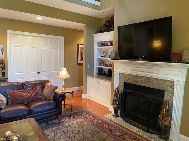 living room featuring a fireplace and light hardwood / wood-style floors