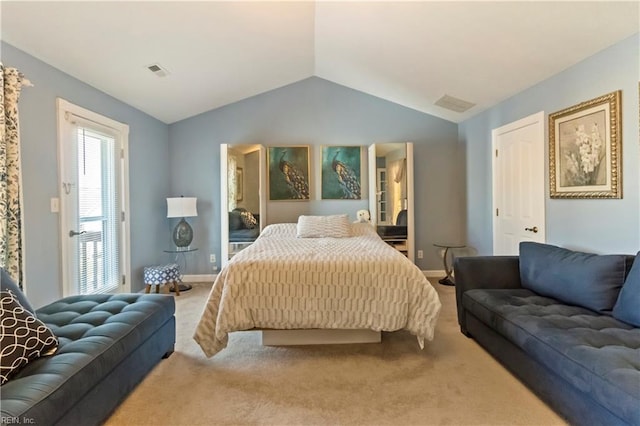 carpeted bedroom with lofted ceiling