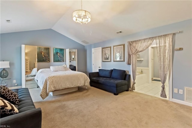 carpeted bedroom with vaulted ceiling and ensuite bathroom