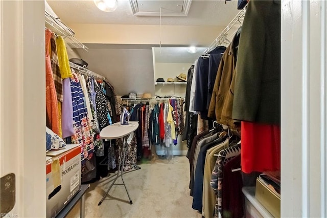 spacious closet featuring light colored carpet