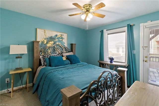 carpeted bedroom with ceiling fan and multiple windows