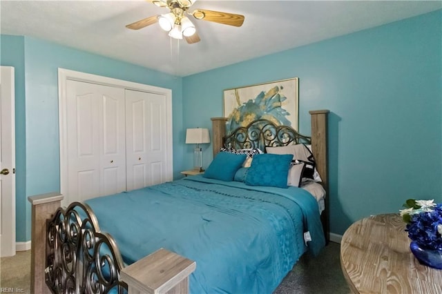 carpeted bedroom featuring ceiling fan and a closet