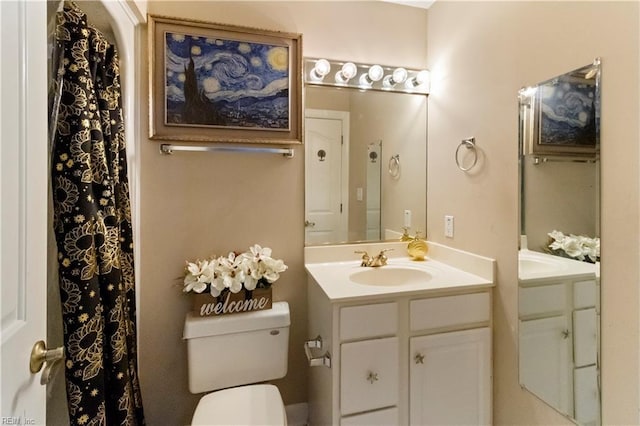 bathroom featuring vanity and toilet