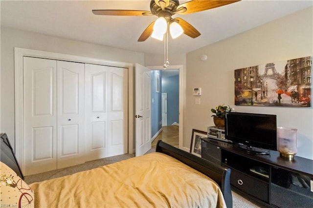 bedroom with ceiling fan and a closet