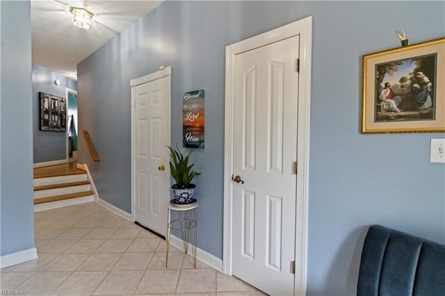 corridor with light tile patterned floors