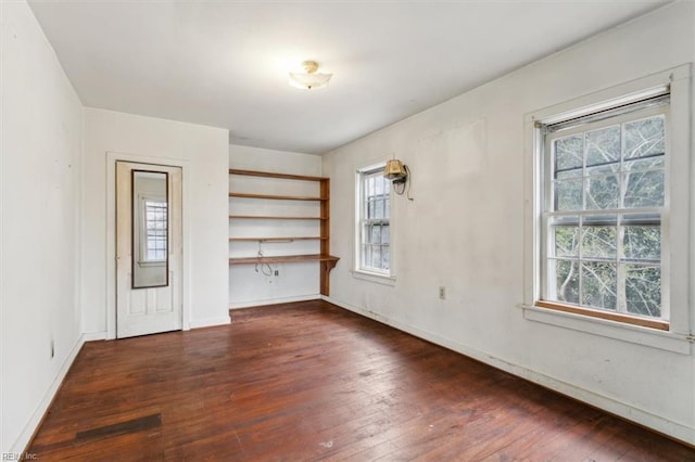 unfurnished room featuring dark wood-type flooring