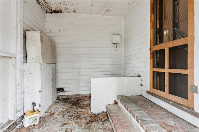 bathroom featuring wooden walls