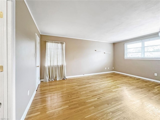 unfurnished room with crown molding and light wood-type flooring