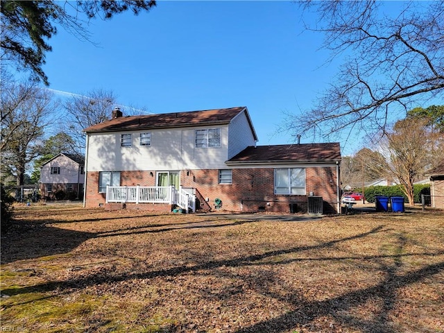 rear view of property featuring a yard