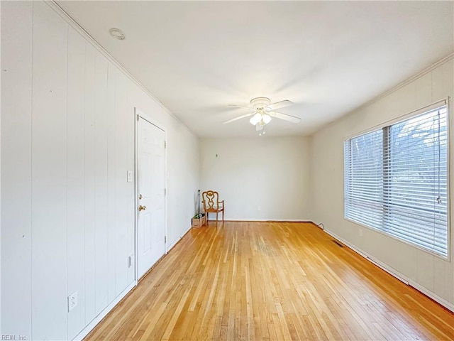 unfurnished room featuring ceiling fan and light wood-type flooring