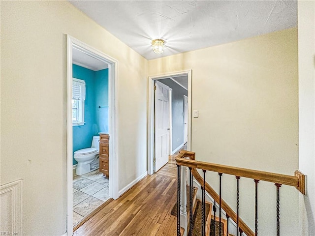 hallway with hardwood / wood-style floors