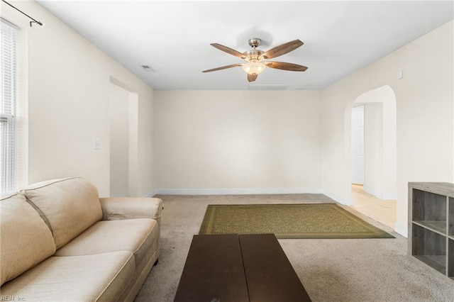 unfurnished living room featuring carpet flooring and ceiling fan