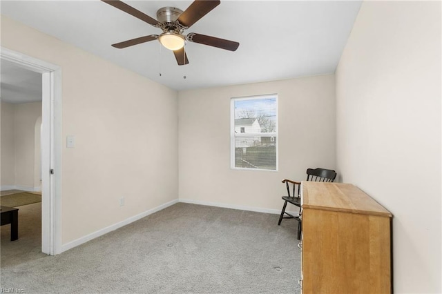 unfurnished office with ceiling fan and light colored carpet