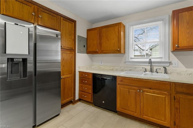 kitchen featuring black dishwasher, sink, stainless steel fridge, and electric panel