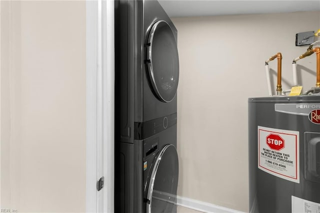 laundry area with electric water heater and stacked washer / drying machine