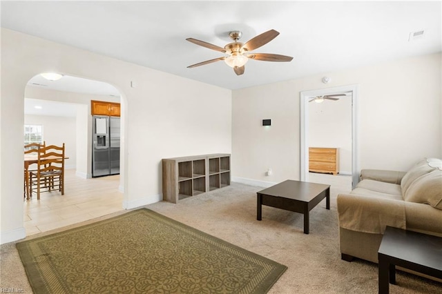 carpeted living room with ceiling fan