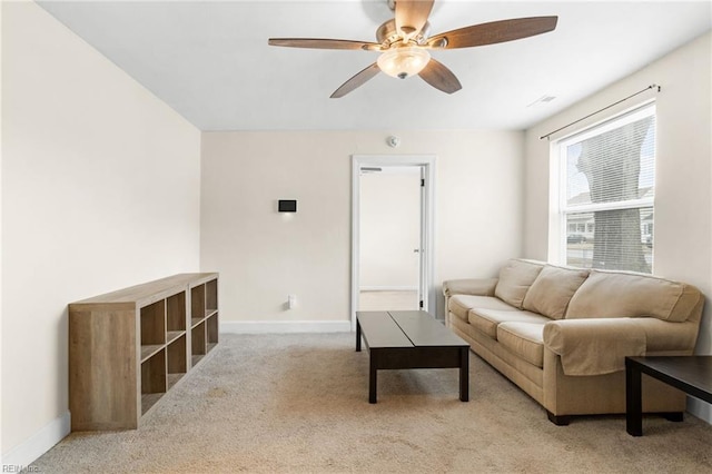 carpeted living room with ceiling fan