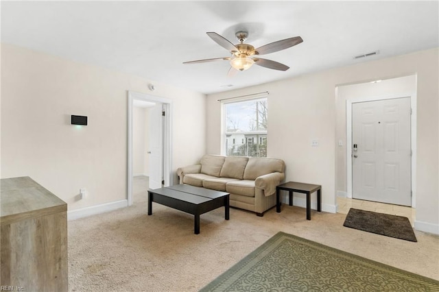 carpeted living room with ceiling fan