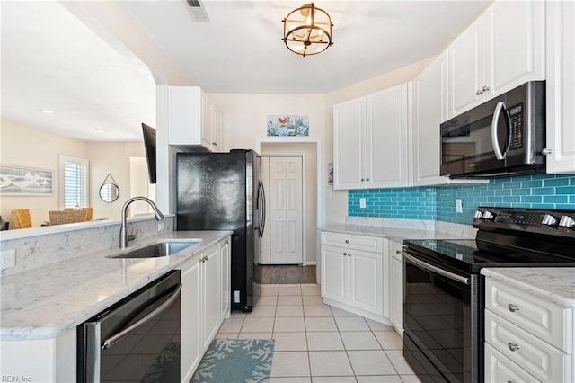 kitchen featuring sink, light stone counters, black appliances, white cabinets, and backsplash