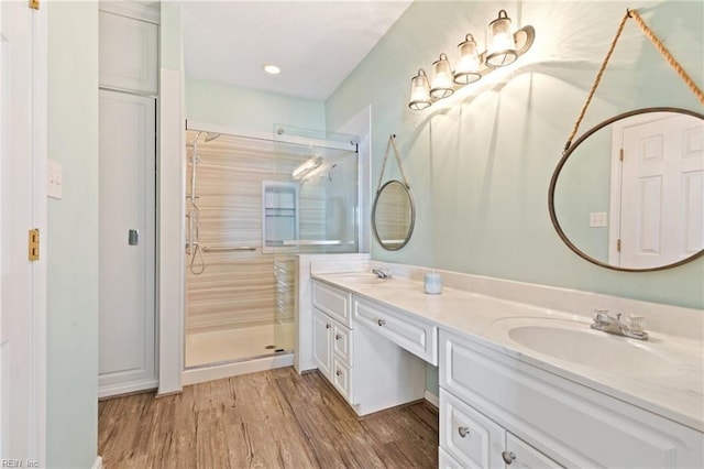 bathroom featuring vanity, hardwood / wood-style flooring, and walk in shower