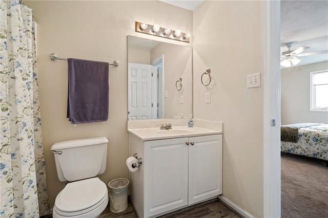 bathroom featuring vanity, ceiling fan, toilet, and walk in shower