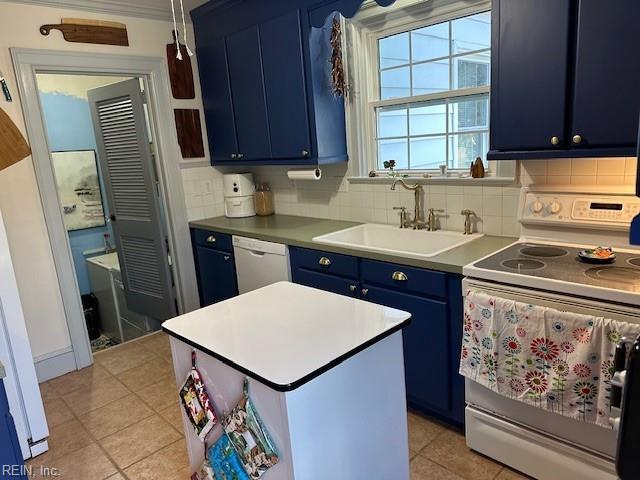 kitchen featuring blue cabinets, tasteful backsplash, sink, and white appliances