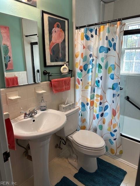 bathroom featuring shower / tub combo with curtain, tile walls, backsplash, tile patterned floors, and toilet