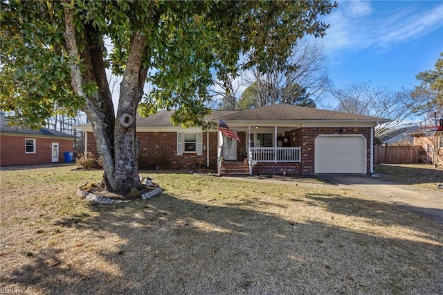 ranch-style home with a garage, covered porch, and a front lawn