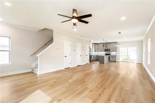 unfurnished living room with crown molding, ceiling fan, and light wood-type flooring