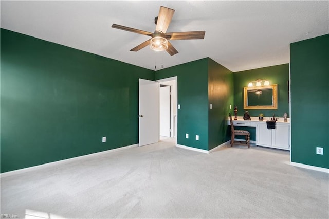 unfurnished bedroom featuring light colored carpet and ceiling fan