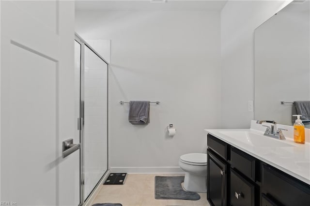 bathroom with vanity, tile patterned flooring, a shower with shower door, and toilet