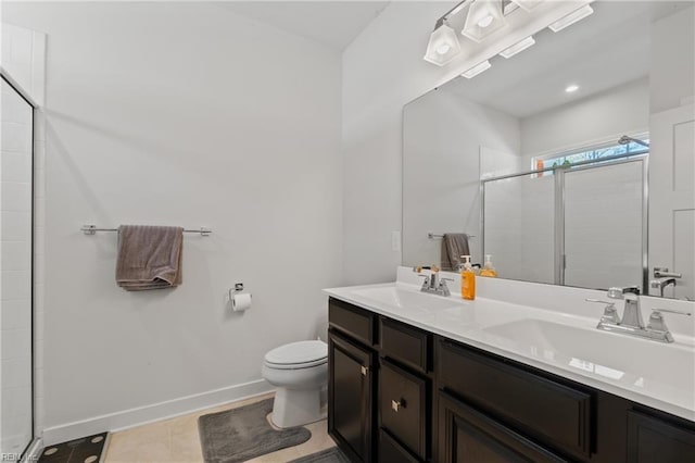 bathroom featuring a shower with door, vanity, tile patterned floors, and toilet