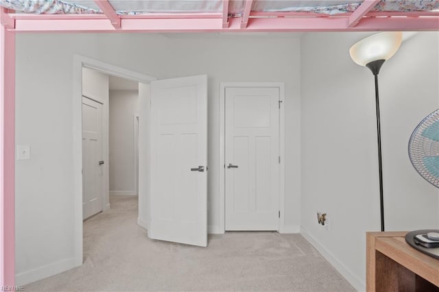 unfurnished bedroom with light colored carpet