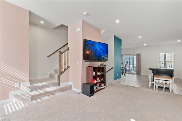 carpeted living room with sink