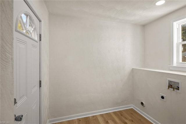 laundry room featuring hookup for an electric dryer, light hardwood / wood-style floors, and hookup for a washing machine