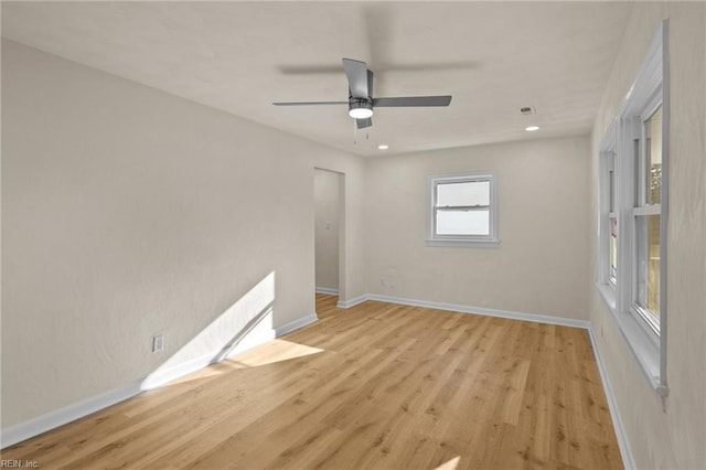 spare room with ceiling fan and light wood-type flooring