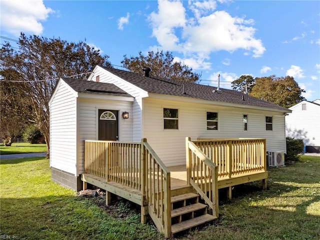 back of property featuring a wooden deck, ac unit, and a lawn