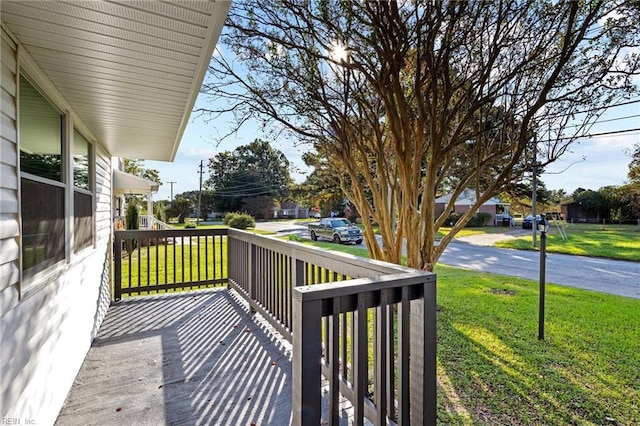 wooden terrace with a porch and a yard