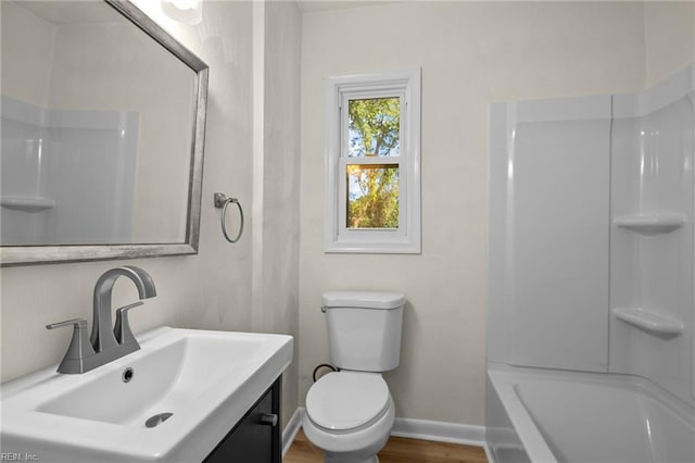 full bathroom featuring hardwood / wood-style flooring, toilet, sink, and shower / bathing tub combination