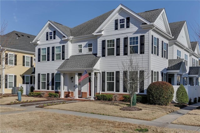 view of front facade with central AC unit and a front yard